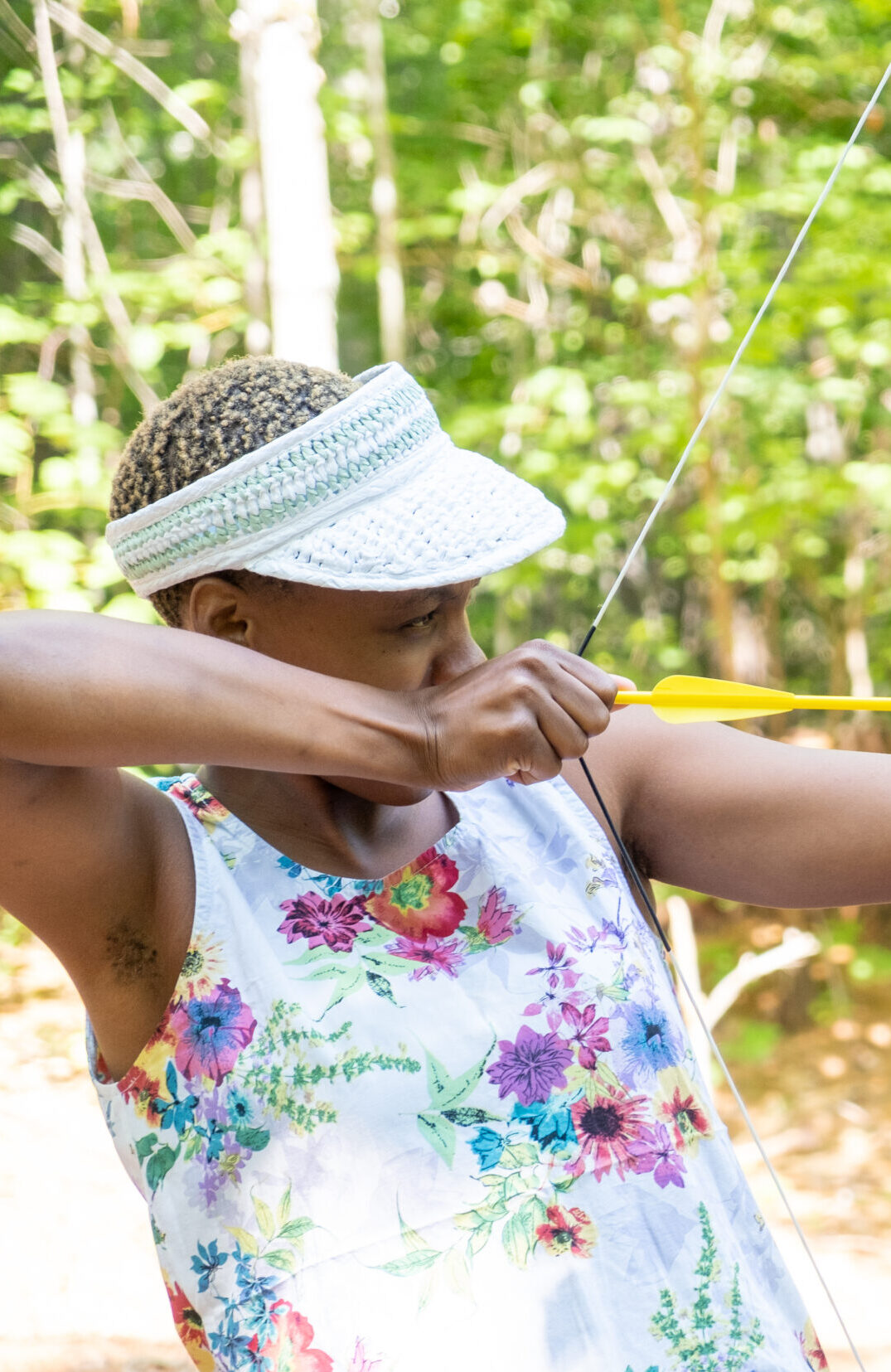 A child at Camp Hale is learning archery